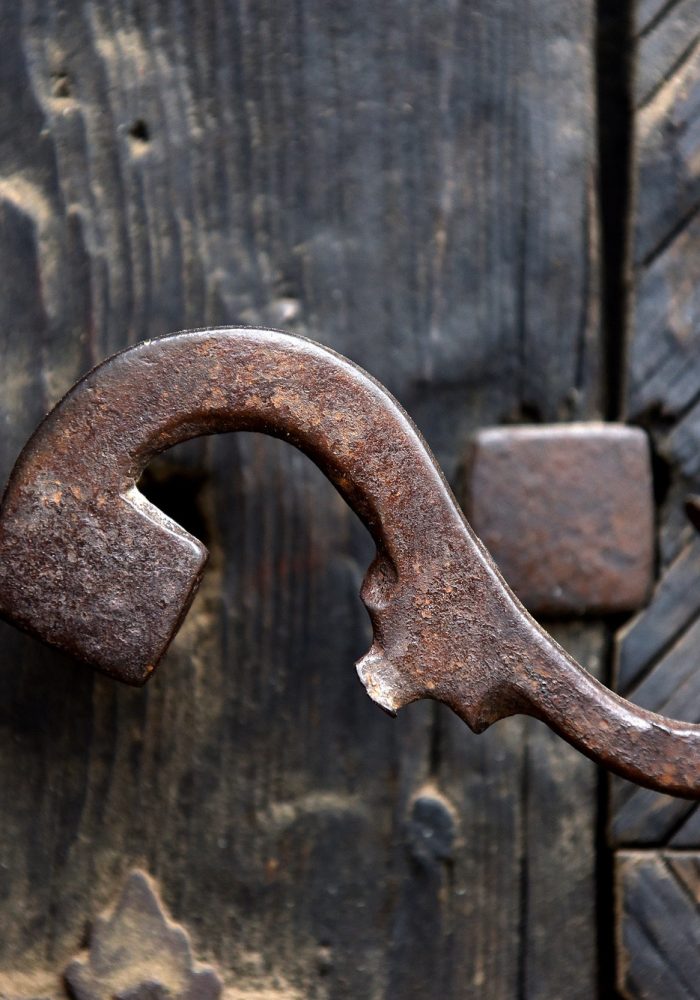 Vintage iron door handle on a wooden door